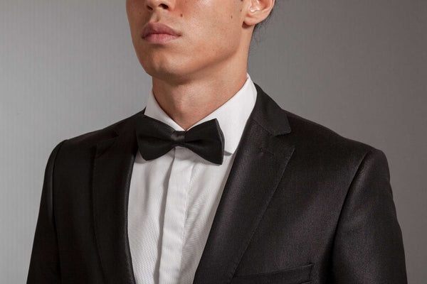 man wearing a tuxedo shirt with a black bowtie