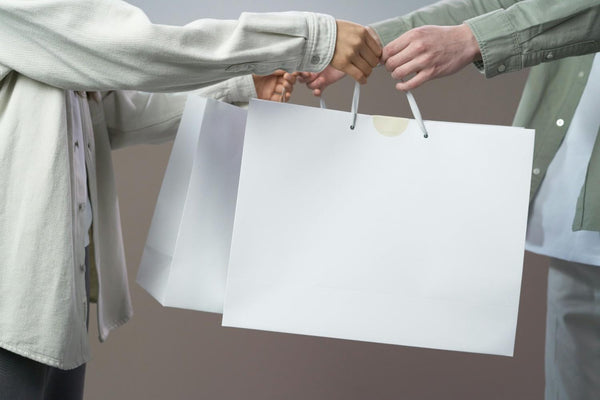 Person in Gray Long Sleeve Shirt Holding White Paper